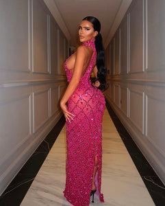 a woman in a pink dress standing in a hallway